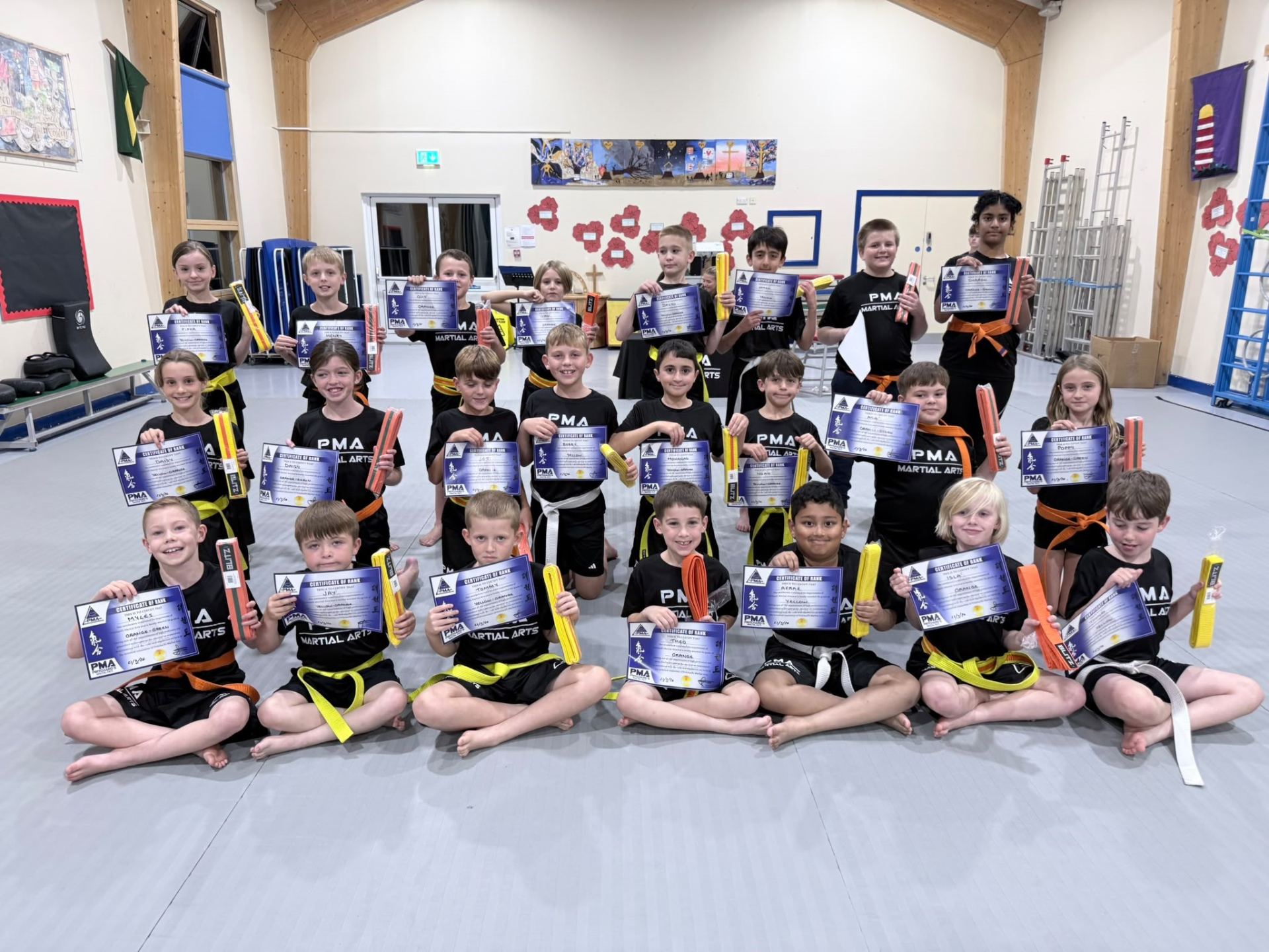 PMA Chester grading class holding their Certificates of Rank and new belts