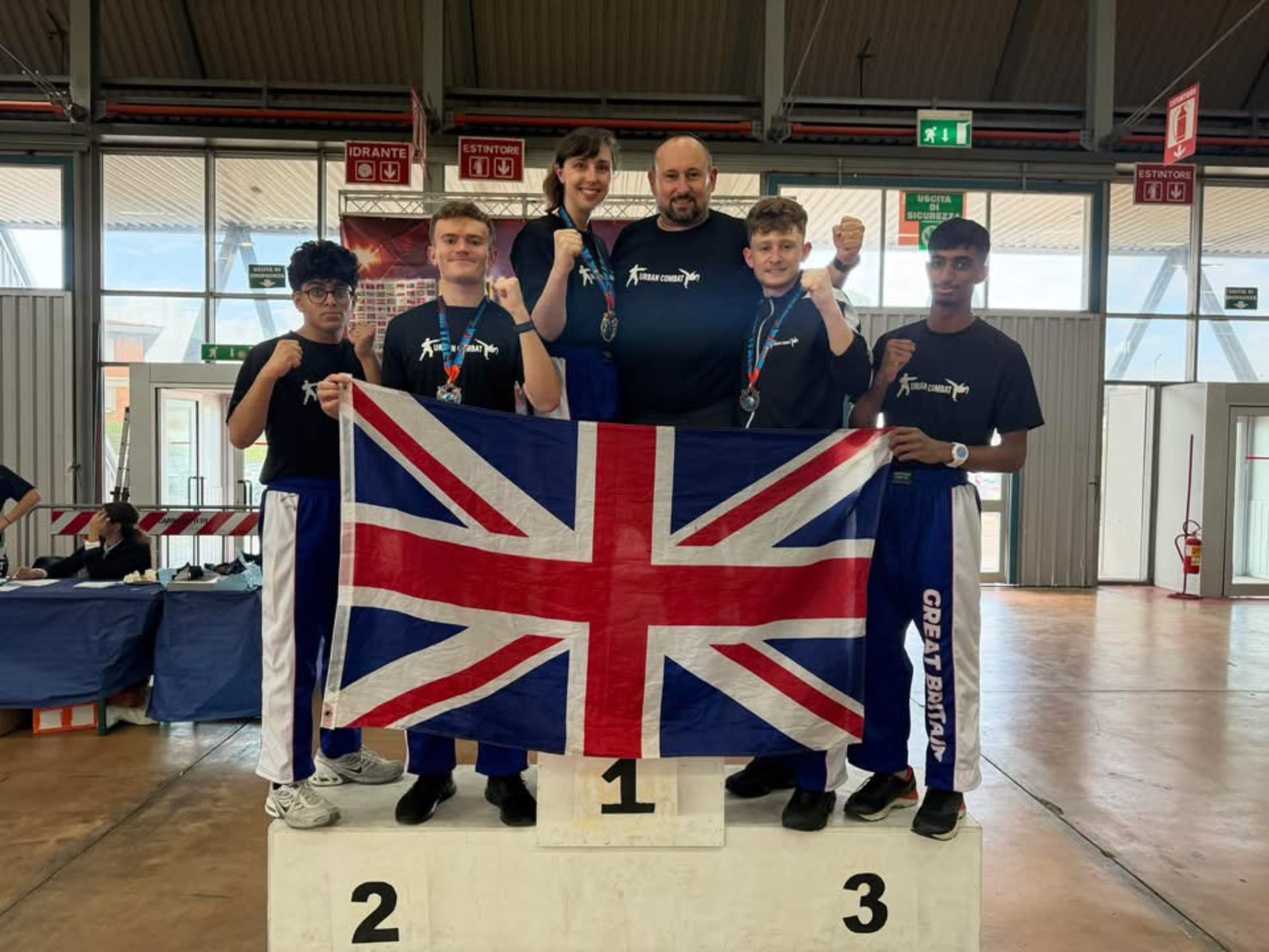 Urban Combat medallists in club shirts and gis after a competition