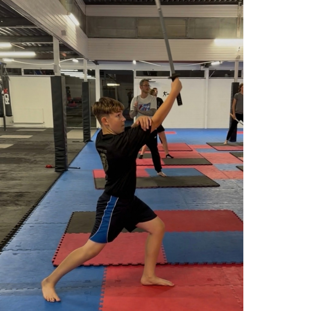 Creative Sword student in a deep lunge with sword raised