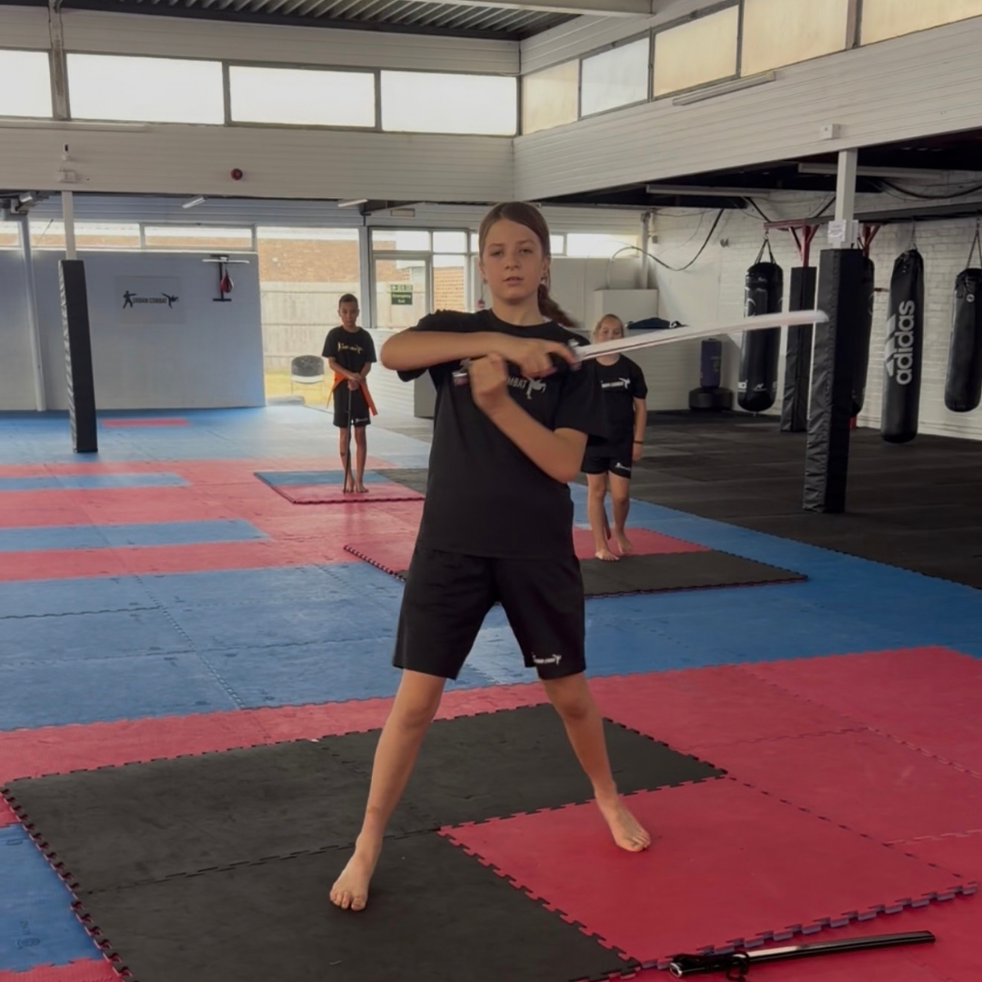 Creative Sword student performing a form with a practice sword at Urban Combat Ipswich