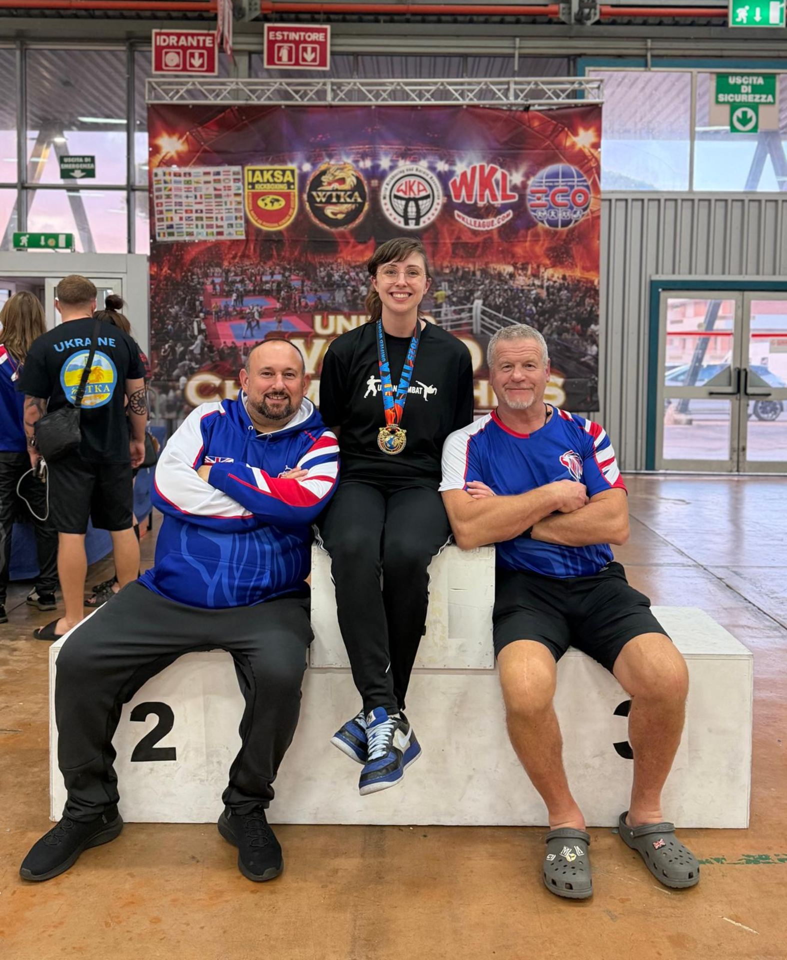 Urban Combat athlete with gold medal on the podium at the WTKA Unified World Championships