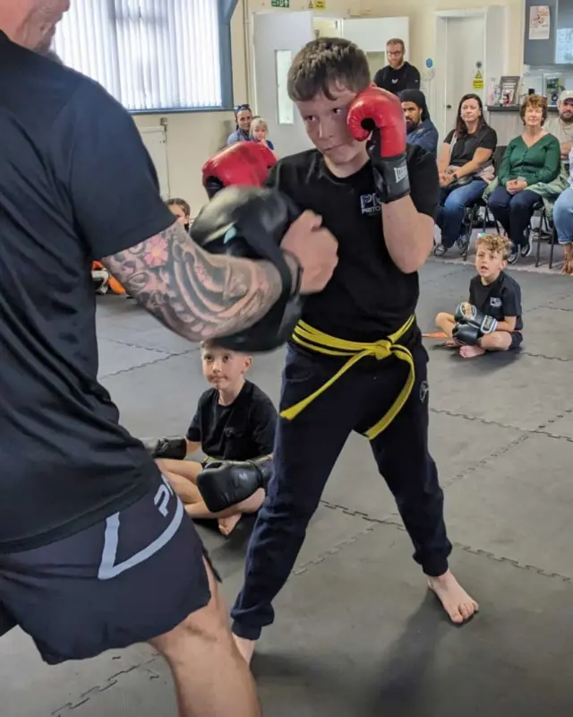 Instructor coaching a martial arts class in Holyhead